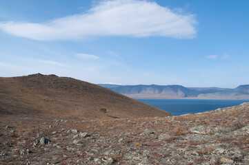 Baikal lake fresh water
flora shore reserve Russia Irkutsk park island Sky clouds clear Olkhon rocks trees embankments sand bay lagoon stones mountains hills horizon line panorama autumn water waves 