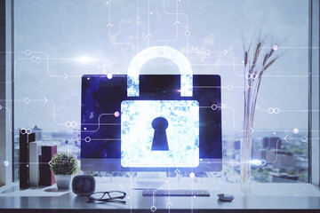 Double exposure of desktop with computer and lock icon hologram. Concept of data safety.