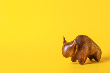 Figurine of bull as symbol of year 2021 on color background