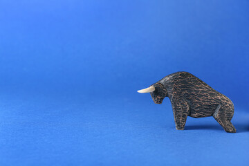 Figurine of bull as symbol of year 2021 on color background