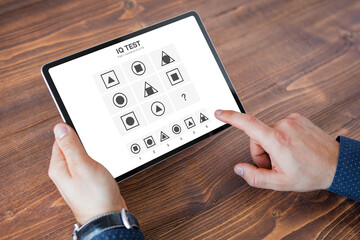 Man taking IQ test on tablet