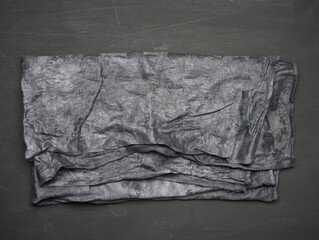black kitchen textile towel folded on a black wooden table