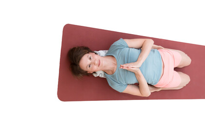 Lying Warrior Pose (Supta Virasana). Young woman does asana with namaste hands on crimson yoga carpet. white background isolated. 