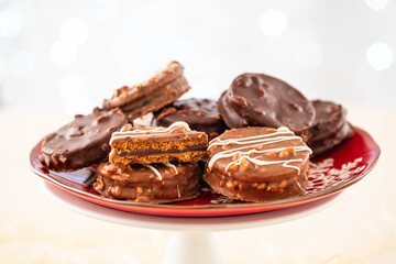Chocolate biscuit sandwich in chocolate and nut glaze on christmas background
