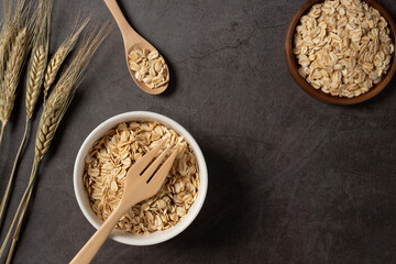 Oat flakes in white bowl top view. Concept healthy eating, dieting and vegetarian food.