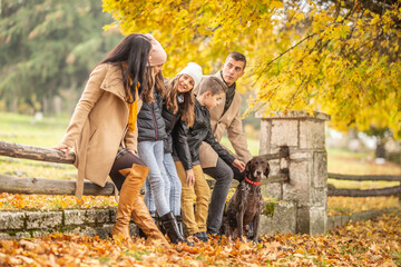 A family talks and enjoys moments outdoors during a colorful fall day