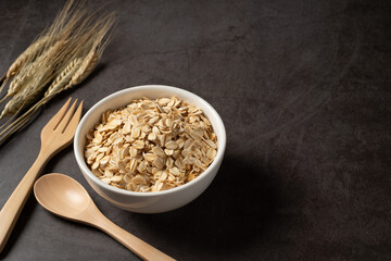 Oat flakes in white bowl top view. Concept healthy eating, dieting and vegetarian food.