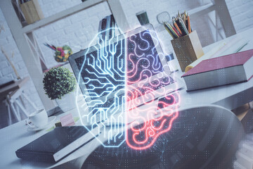 Double exposure of work space with computer and human brain drawing hologram. Brainstorm concept.