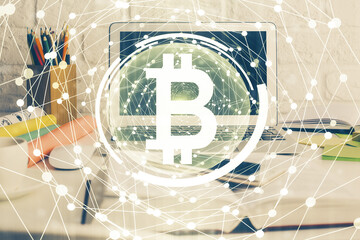 Multi exposure of blockchain and crypto economy theme hologram and table with computer background. Concept of bitcoin cryptocurrency.