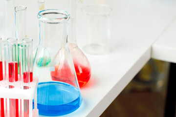 Laboratory glassware with color liquids close up