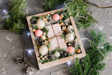Christmas pink box on the table and light garland