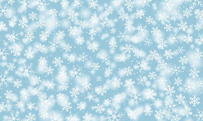 Snow background. Winter snowfall. White snowflakes on blue sky. Christmas background. Falling snow.