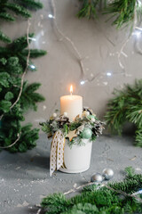 Сhristmas composition with candlesticks and white candle