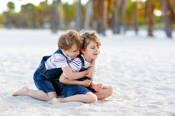 Fototapeta na wymiar Two little kids boys having fun on tropical beach