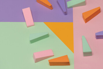 Top view of multi-colored sponges on different pastel-colored backgrounds. Abstract image