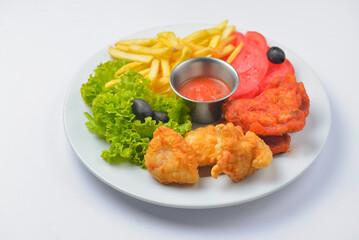 Buffalo chicken wings with tomato dip sauce. Served on a white plate over white background.