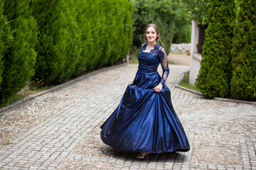 Beautiful girl in glamorous ultramarine dress. Ready for her prom night.