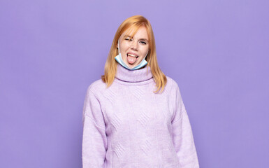 pretty woman  with cheerful, carefree, rebellious attitude, joking and sticking tongue out, having...