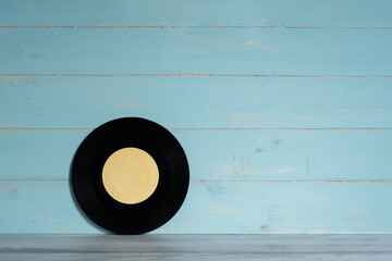 Vinyl record on wooden background,vintage style