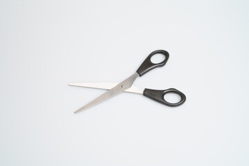 stainless steel scissors with black handle laid