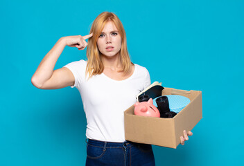 pretty woman  feeling confused and puzzled, showing you are insane, crazy or out of your mind