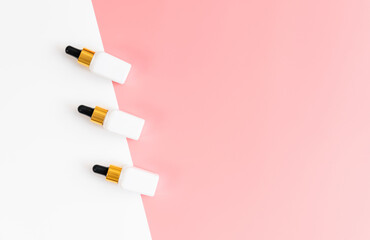 White bottle cream, mockup of beauty product brand. Top view on the pink background.