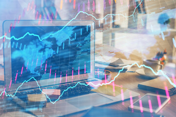 Financial graph colorful drawing and table with computer on background. Multi exposure. Concept of...