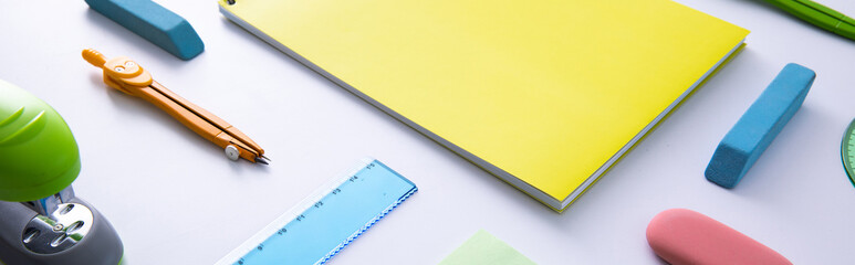 collection of bright colorful stationery on light background, close view . High quality photo