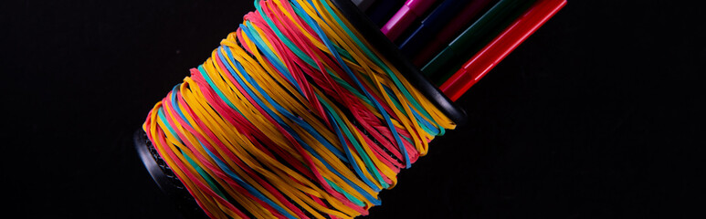 collection of colorful felt-tip pens in cup on dark background, close view. High quality photo