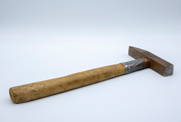 Old rusty hammer on a white background. Copy space for text.