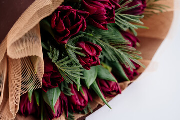 Close-up bouquet of flowers in burgundy package