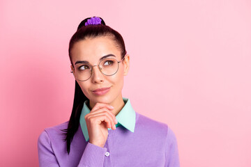 Photo of young woman look up empty space hand finger chin wear specs purple cardigan isolated pink color background