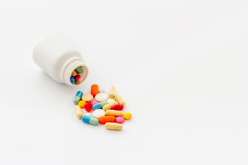 Heap of pills with drug bottle close up