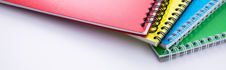collection of colorful notebooks isolated on white background, close view. High quality photo