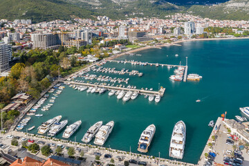 Aerial shot of the marina of a small Adriatic town, aerial view of yachts and boats in marina. Budva, Adriatic sea, Montenegro