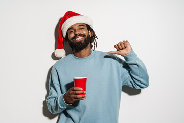 Young happy african man in red santa hat