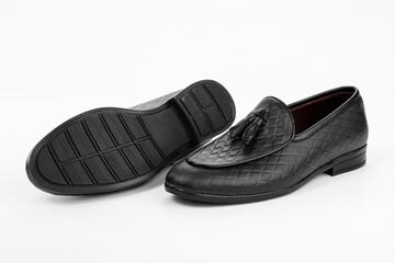 A pair of classic black men's shoes on a white background