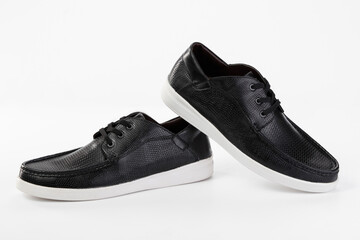 A pair of classic black men's shoes on a white background