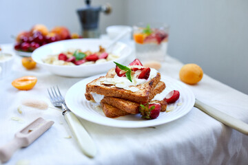 Fresh and bright continental breakfast table, abundance healthy meal variety french toast, fruits, lemonade, coffee,  on  table served.