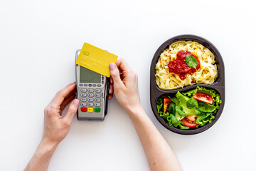 Food delivery payment with terminal and lunch boxes with meal
