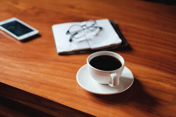 A cup of coffee placed on the desk during relax time