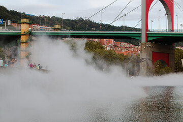 BILBAO, SPAIN - Aug 16, 2020: La niebla de Bilbao avanza tragando se a la gente que se encuentra en...