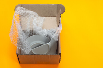 A parcel from an online store packed in a box, the dishes were broken when opened