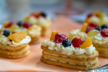 dessert of cream cookies and fruits on a festive table