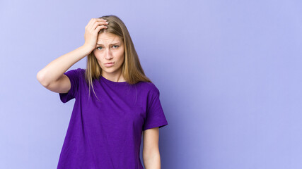 Fototapeta premium Young blonde woman isolated on purple background being shocked, she has remembered important meeting.