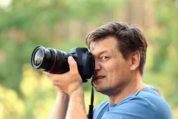 a man with a camera in the forest