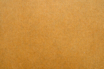 Close up of brown envelope texture on white background.