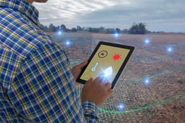 smart agriculture concept, farmer use tablet read infrared in soil with high definition soil...