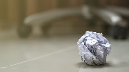 Crumpled balls of white paper on the floor.