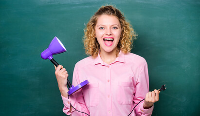 Teacher hold table lamp in hand chalkboard background. Insight and idea. Educational idea. Woman...